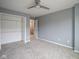 Inviting bedroom with soft carpeting, a ceiling fan, and a closet offering convenient storage solutions at 256 Strand Ln # Apt C, Avon, IN 46123