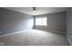 Bedroom with plush gray carpet, neutral paint, and bright window at 256 Strand Ln # Apt C, Avon, IN 46123