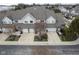 View of townhome exteriors featuring attached garages, private entrances, and shared green spaces at 256 Strand Ln # Apt C, Avon, IN 46123