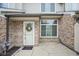 Close-up shot of the front entrance featuring a white door with a wreath and a small patio area at 256 Strand Ln # Apt C, Avon, IN 46123
