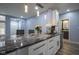 Modern kitchen boasts black marble countertop island with sink and stainless steel dishwasher at 256 Strand Ln # Apt C, Avon, IN 46123
