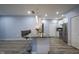 Kitchen, dining, and living space with wood flooring, kitchen bar with stools, and stainless steel appliances at 256 Strand Ln # Apt C, Avon, IN 46123