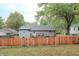 Backyard view of home featuring a wooden fence, lawn, and deck area on the rear of the house at 316 Laurel St, Pendleton, IN 46064