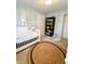 Bright Bedroom featuring a crib, round jute rug, and modern decor at 316 Laurel St, Pendleton, IN 46064