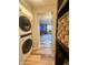 Hallway with in-unit laundry machines and view into the living room area at 316 Laurel St, Pendleton, IN 46064