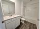 Bathroom featuring a single sink vanity with quartz countertops and a shower/tub combo at 3181 W Keepsake Ln, Monrovia, IN 46157