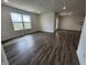 Bright living room featuring wood-look floors and abundant natural light at 3181 W Keepsake Ln, Monrovia, IN 46157