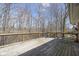 Wood deck overlooking a backyard with mature trees, providing a private outdoor space at 3334 Eden Village Pl, Carmel, IN 46033