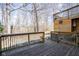 Spacious back deck overlooking the wooded yard featuring wood railing at 3334 Eden Village Pl, Carmel, IN 46033