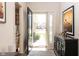 Inviting entryway with an open door, decorative glass, tile floors, and a stylish console table, creating a welcoming first impression at 3334 Eden Village Pl, Carmel, IN 46033