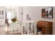 Bright hallway featuring a desk, staircase with picture frames, and a decorative flower arrangement at 3334 Eden Village Pl, Carmel, IN 46033