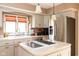 Well-equipped kitchen featuring stainless steel appliances, a central island with cooktop, and ample counter space at 3334 Eden Village Pl, Carmel, IN 46033