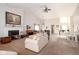 Spacious living room with a fireplace, comfortable sofas, and ample natural light, perfect for relaxation and entertaining at 3334 Eden Village Pl, Carmel, IN 46033