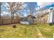 Spacious backyard featuring a shed, fire pit, and lush green grass at 4429 Tucson Dr, Indianapolis, IN 46241