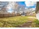 Large backyard with a green lawn, shed, and a tall wooden privacy fence at 4429 Tucson Dr, Indianapolis, IN 46241