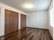Bedroom featuring wood-look vinyl floors and closet doors at 4429 Tucson Dr, Indianapolis, IN 46241