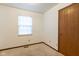 A bright bedroom features a window, closet, and neutral carpeting at 4429 Tucson Dr, Indianapolis, IN 46241