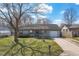 Ranch-style home featuring a covered front porch, well-manicured lawn, and driveway at 4429 Tucson Dr, Indianapolis, IN 46241