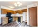 Well-lit kitchen with wood cabinets, black appliances, and vinyl flooring at 4429 Tucson Dr, Indianapolis, IN 46241