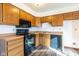 Kitchen features wood cabinets, laminate countertops, and black appliances at 4429 Tucson Dr, Indianapolis, IN 46241