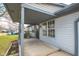 Covered porch with grey wood posts, concrete floor, and a view of the front yard at 4429 Tucson Dr, Indianapolis, IN 46241