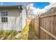Narrow side yard enclosed by a wooden fence and the side of the home at 4429 Tucson Dr, Indianapolis, IN 46241