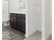 The bathroom features a double sink, wood look flooring, and open shelving at 4712 E Shadowbrook Dr, Camby, IN 46113