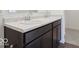 Bathroom features a double sink, dark wood cabinet, marble countertop, and brushed nickel hardware at 4712 E Shadowbrook Dr, Camby, IN 46113