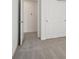 Bedroom with closet doors and neutral carpet, bathed in natural light from an adjacent room at 4712 E Shadowbrook Dr, Camby, IN 46113