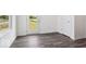 Bedroom with dark gray hardwood flooring, white walls, and walk out access to the lawn at 4712 E Shadowbrook Dr, Camby, IN 46113
