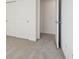 Bedroom with closet doors and neutral carpet, bathed in natural light from an adjacent room at 4712 E Shadowbrook Dr, Camby, IN 46113