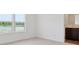 Bedroom featuring neutral carpet, white walls, two windows, and a view into bathroom at 4712 E Shadowbrook Dr, Camby, IN 46113