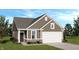 Charming single-story home featuring a brick foundation, two-car garage, and a well-manicured lawn at 4712 E Shadowbrook Dr, Camby, IN 46113