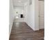 Open hallway with durable wood-look flooring leading to a bright kitchen and other rooms at 4712 E Shadowbrook Dr, Camby, IN 46113