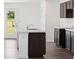 Contemporary kitchen featuring dark cabinets, an island with a white countertop, and stainless steel appliances at 4712 E Shadowbrook Dr, Camby, IN 46113