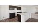 Contemporary kitchen with dark wood cabinets, an island with white countertop, and modern stainless steel sink at 4712 E Shadowbrook Dr, Camby, IN 46113