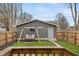 Beautiful backyard featuring a swing and a newly landscaped area, all set within a fenced perimeter at 5226 E St Clair St, Indianapolis, IN 46219