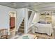 Finished basement with a sleeping area, exposed ceiling, and updated flooring at 5226 E St Clair St, Indianapolis, IN 46219