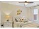 Cozy bedroom features a comfortable bed with decorative pillows, a nightstand, and a ceiling fan at 5226 E St Clair St, Indianapolis, IN 46219