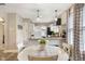 Open-concept dining area next to the modern kitchen with pendant lighting at 5226 E St Clair St, Indianapolis, IN 46219