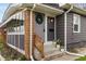 Inviting front entrance with wreath, updated gray paint, and lovely landscaping at 5226 E St Clair St, Indianapolis, IN 46219