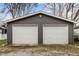 Detached two-car garage with white doors providing secure parking and additional storage at 5226 E St Clair St, Indianapolis, IN 46219