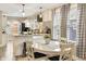 Inviting kitchen with white cabinetry, granite countertops, stainless steel appliances, and cozy breakfast nook with bright windows at 5226 E St Clair St, Indianapolis, IN 46219