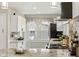 Stylish kitchen featuring granite countertops, grey tile backsplash, white cabinets, and modern stainless steel appliances at 5226 E St Clair St, Indianapolis, IN 46219