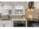 Modern kitchen with granite countertops, black appliances, and a stylish grey subway tile backsplash at 5226 E St Clair St, Indianapolis, IN 46219