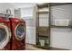 Convenient laundry room features modern washer and dryer set and built-in storage shelves at 5226 E St Clair St, Indianapolis, IN 46219