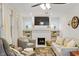 Bright living room boasts a decorative fireplace, built-in shelving, and stylish furnishings at 5226 E St Clair St, Indianapolis, IN 46219