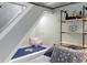 Cozy reading nook under the stairs, complete with soft pillows and built-in shelves at 5226 E St Clair St, Indianapolis, IN 46219