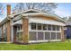 Charming sunroom features awning, brick accents, and ample natural light at 5226 E St Clair St, Indianapolis, IN 46219
