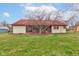 Backyard view of the home showing the screened in porch and expansive lawn at 528 Wind Skip Cir, Westfield, IN 46074